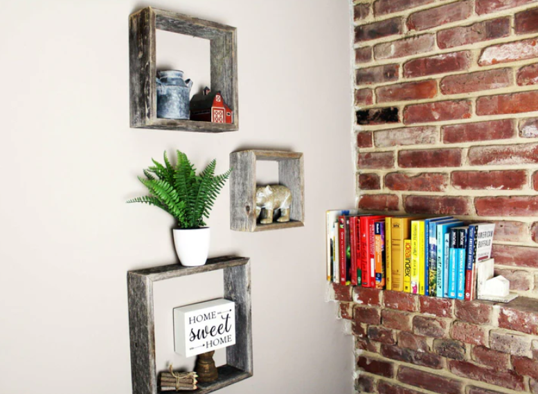 Reclaimed wood shelves on wall next to accent wall with decor