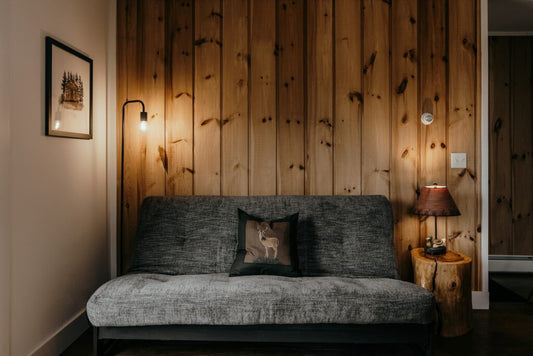 Reclaimed wood wall paneling with couch and lamps