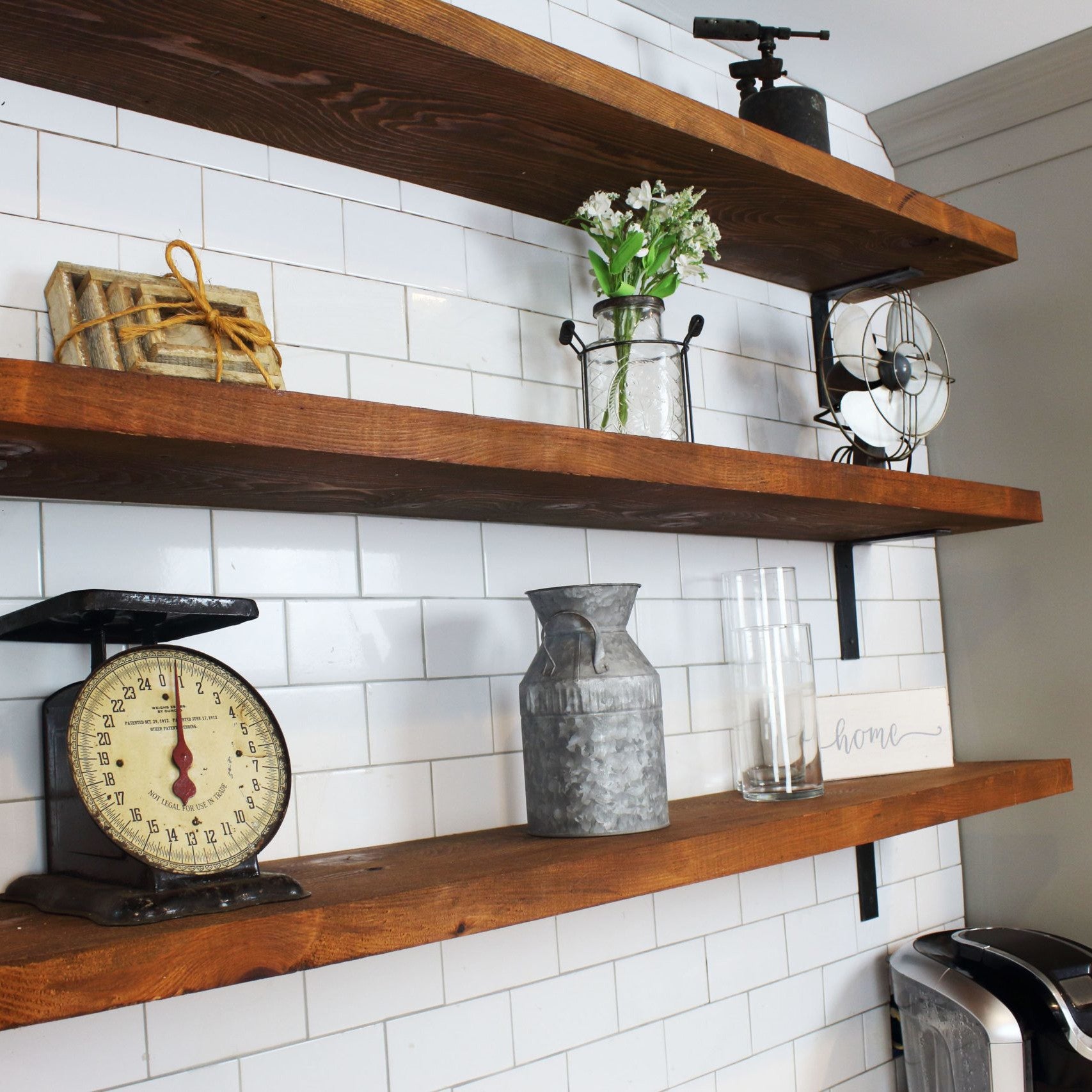 Reclaimed barnwood wall shelves on white wall with decore.