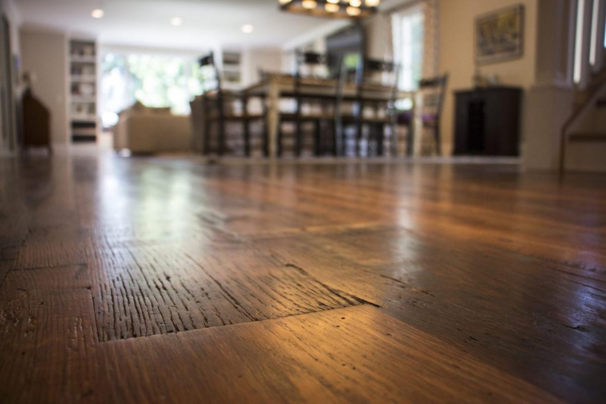 Heartland Barnwood Oak Red & White Mixed Skip-Planed Brown wood flooring close up with blurred background.