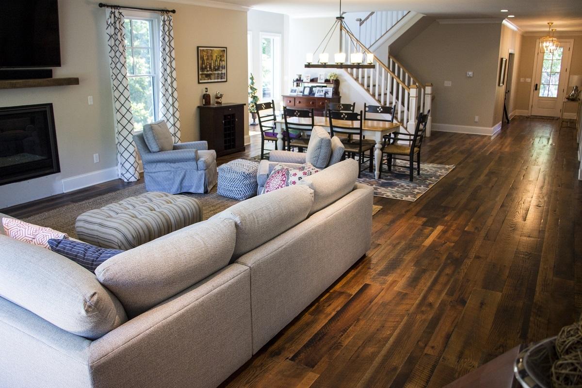 Heartland Barnwood Oak Red & White Mixed Skip-Planed Brown wood flooring in living area and dining area