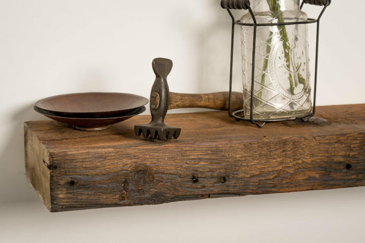 close up of reclaimed wood floating fireplace mantel in the oil finish. Characteristics shown are nail holes, knots, and grain patterns.