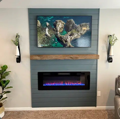 a reclaimed wood floating fireplace mantel in the natural option. Mantel provides contrast to darker colored shiplap fireplace it is mounted on.