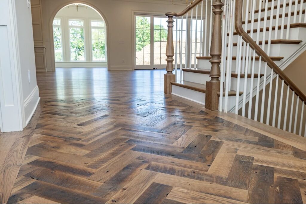 Close up of Heartland Barnwood Oak Red & White Mixed Skip-Planed Brown wood flooring in stair well