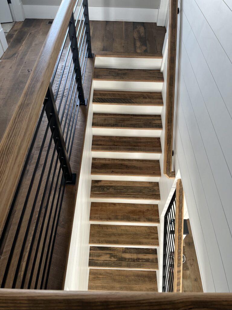 Heartland Barnwood Oak Red & White Mixed Skip-Planed Brown wood flooring in star well and on stairs