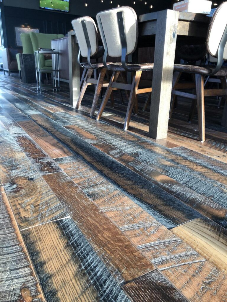 close up of Heartland Barnwood Oak Red & White Mixed Skip-Planed Brown wood flooring in business common area