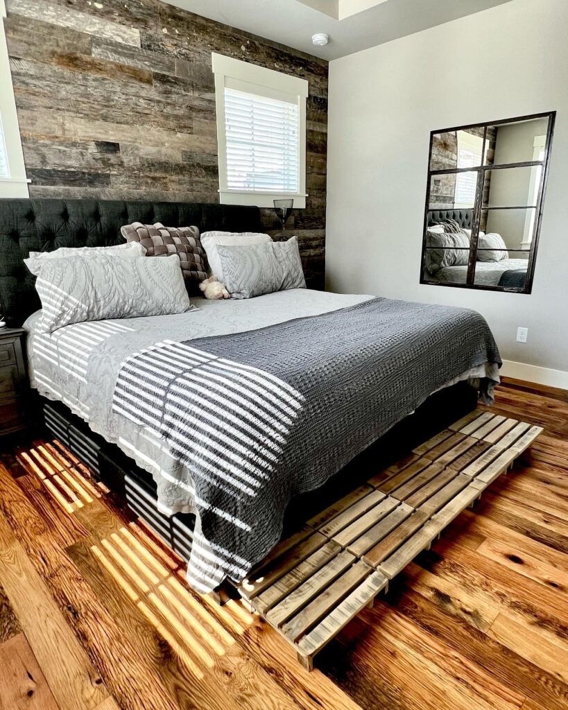 Racehorse Oak Red & White Mix Skip/Wire-Brushed flooring in bedroom with modern bed and wood wall paneling and wall mirror