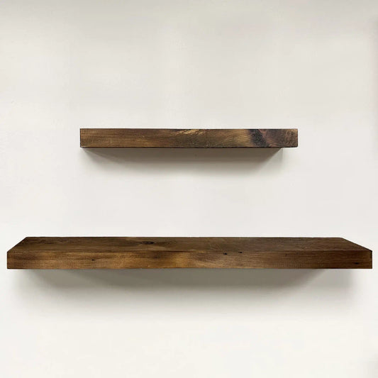 a set of two reclaimed wood floating shelves in the early american finish. Variations in wood color, knots, and grain patterns are present in the wood.