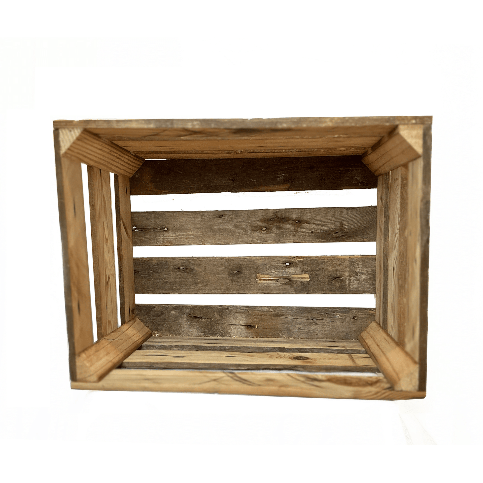 looking inside of a large wooden crate. There are four slats across the bottom with spaces in between. Each corner has a support.