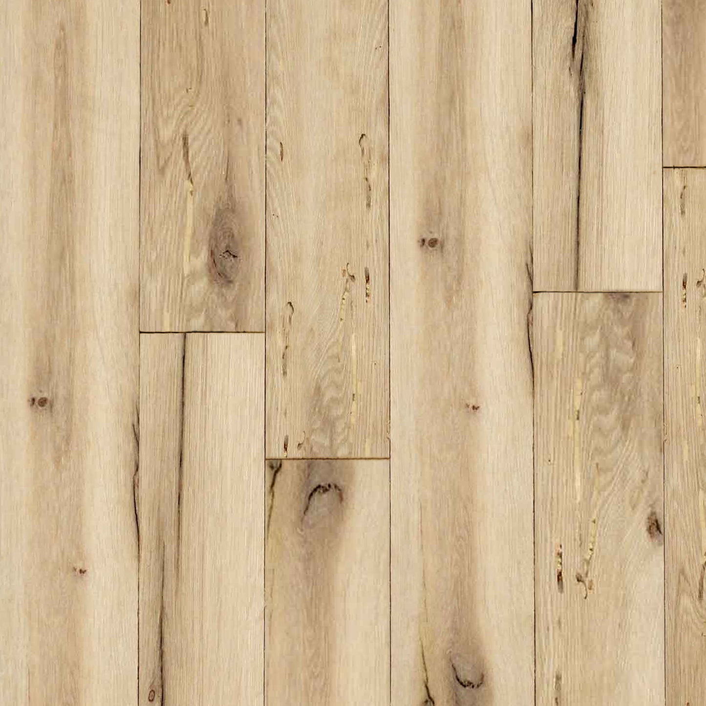 close up of reclaimed white oak flooring installed. Variations in wood color shown along with knots, checking, and characteristics from previous bug activity.