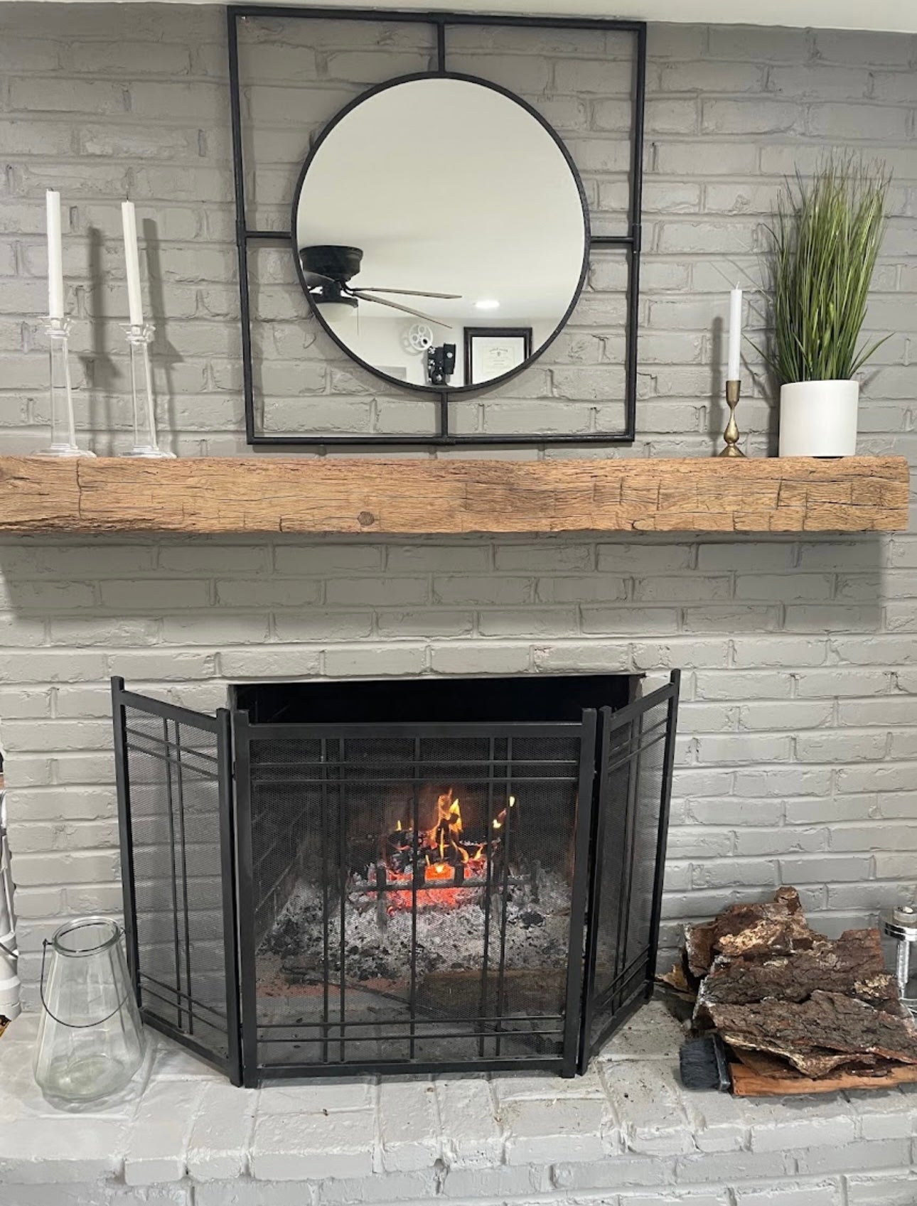 Reclaimed wood mantel on brick fireplace