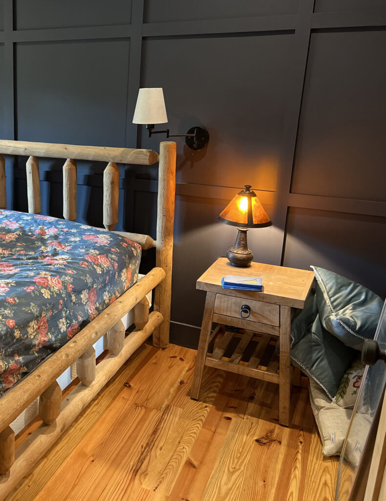 yellow pine wood flooring in bedroom with wood frame bed and wooden night stand