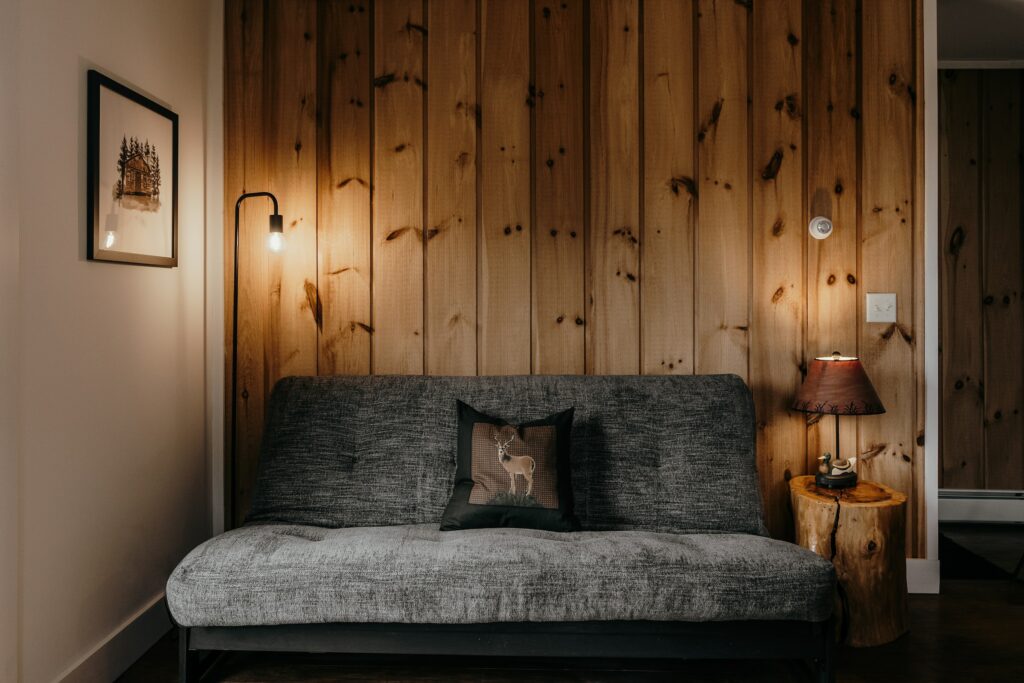 Reclaimed wood wall paneling with couch and lamps