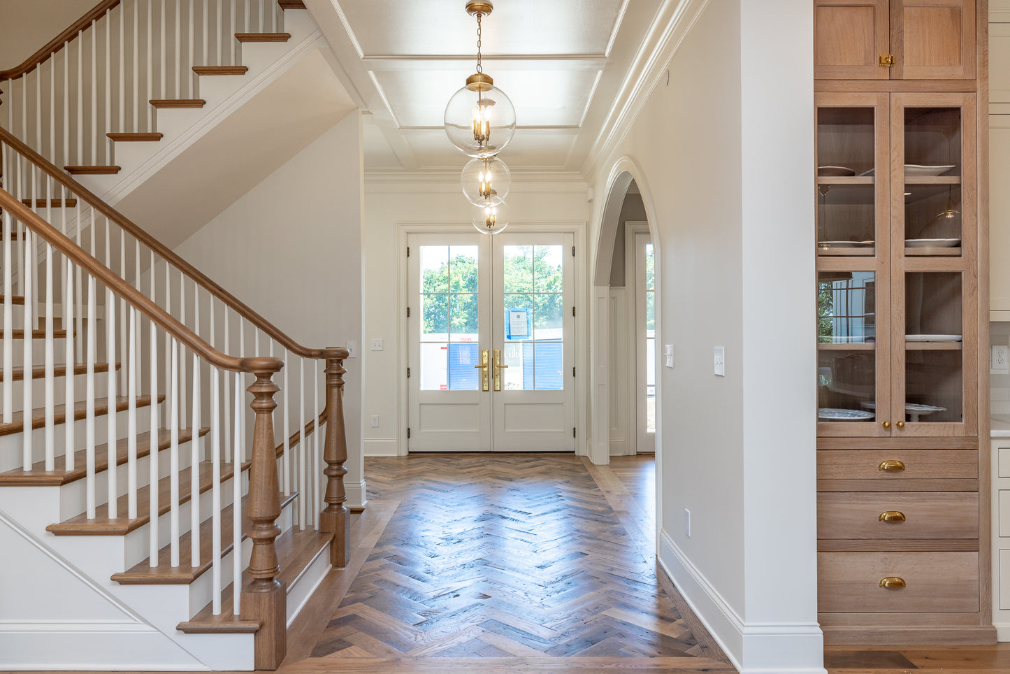 Heartland Barnwood Mixed Hardwoods Clean Face wood flooring in entrance with stairs and wood cabinet.