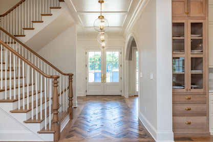 Heartland Barnwood Mixed Hardwoods Clean Face wood flooring in entrance with stairs and wood cabinet.