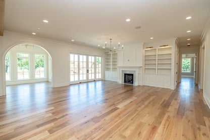 Heartland Barnwood Mixed Hardwoods Clean Face wood flooring in living room with fireplace.