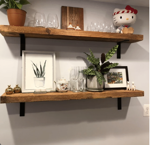 two reclaimed barnwood wall shelves shown in the natural option. The grain patterns and knots within the wood are highlighted on the face of the shelves.