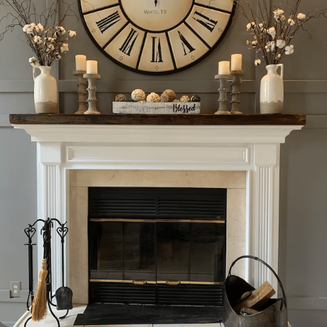 reclaimed barnwood fireplace mantel displayed over a fireplace and hearth.