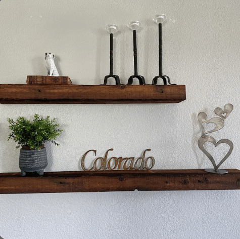 two reclaimed barnwood floating shelves in an oil finish. The oil finish highlights characteristics in the wood and nail holes are on display.