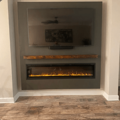 reclaimed barnwood fireplace mantel displayed over a lit fireplace with a television mounted overtop. Oil finish on the mantel brings out variances in the wood coloration.