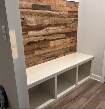 barnwood paneling on a wall in a mudroom. Barnwood paneling on wall is varied in width and length, showing many variations and characteristics. Paneling provides a good contrast to lighter colors in the room shown.