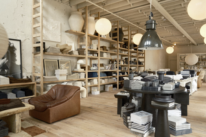 Reclaimed Wood Flooring in room with towels on shelves and displays