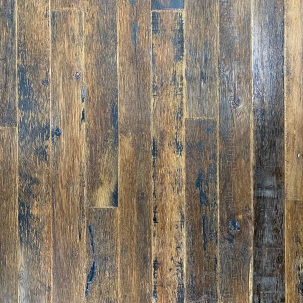 close up of Reclaimed Kentucky Race Horse Fence Plank flooring showing various color tones and characteristics of reclaimed wood such as saw marks and knots.