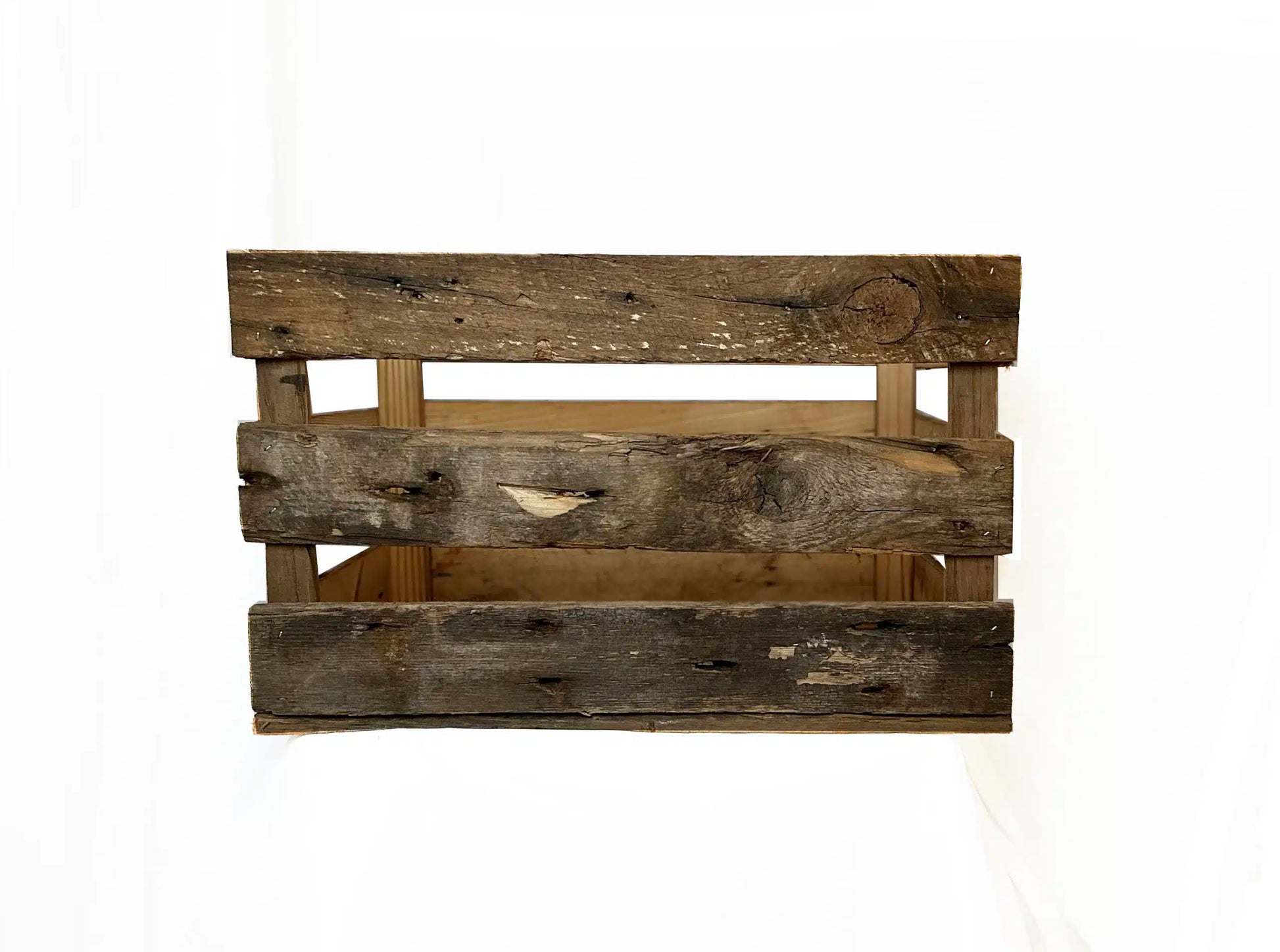 reclaimed wood crate with spaces in between the slats. There are three slats with an equal space in between. Wood displays distressed characteristics.
