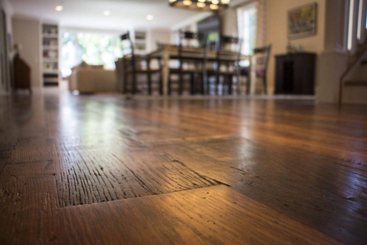 Heartland Barnwood Oak Red & White Mixed Skip-Planed Brown wood flooring  close up with blurred background.