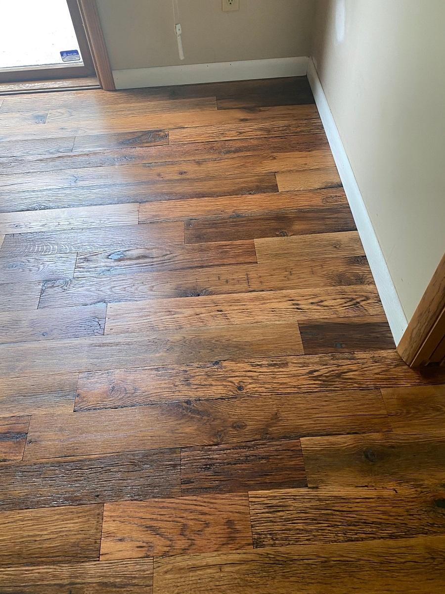 Close up of Racehorse Oak Red & White Mix Skip/Wire-Brushed flooring in common area