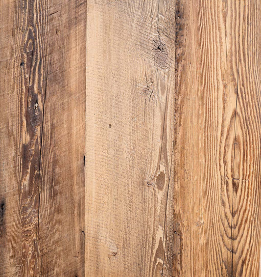 close up of barnwood paneling showing grain pattern and color variation.