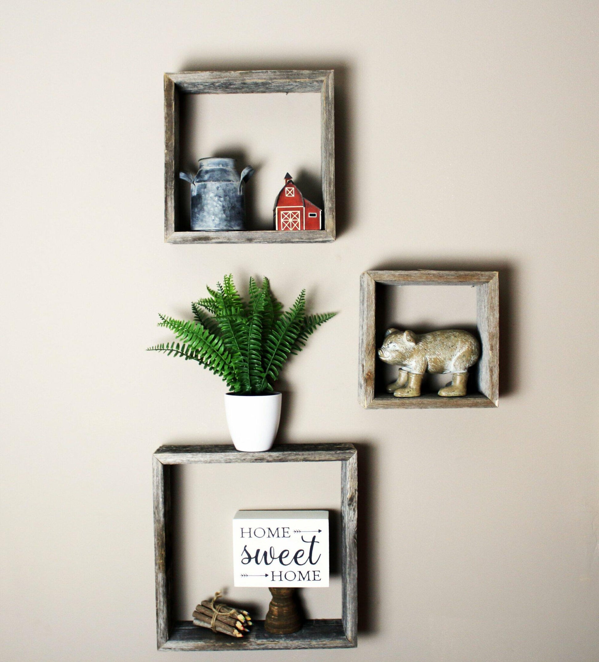 three open box floating shelves in small, medium, and large sizes. Open box shelves shown decorated on a wall.