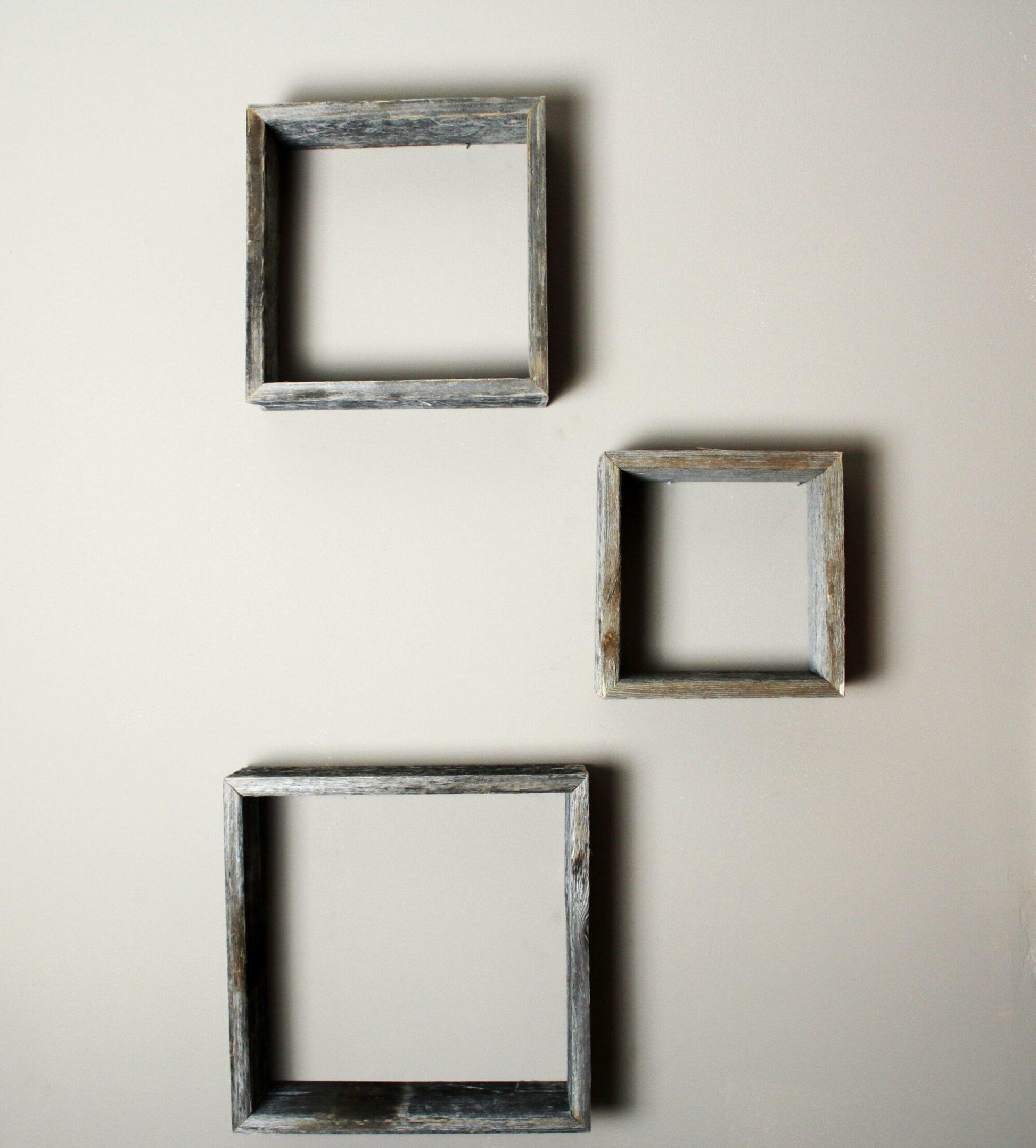 three open box floating shelves in small, medium, and large sizes shown on a wall without decor.