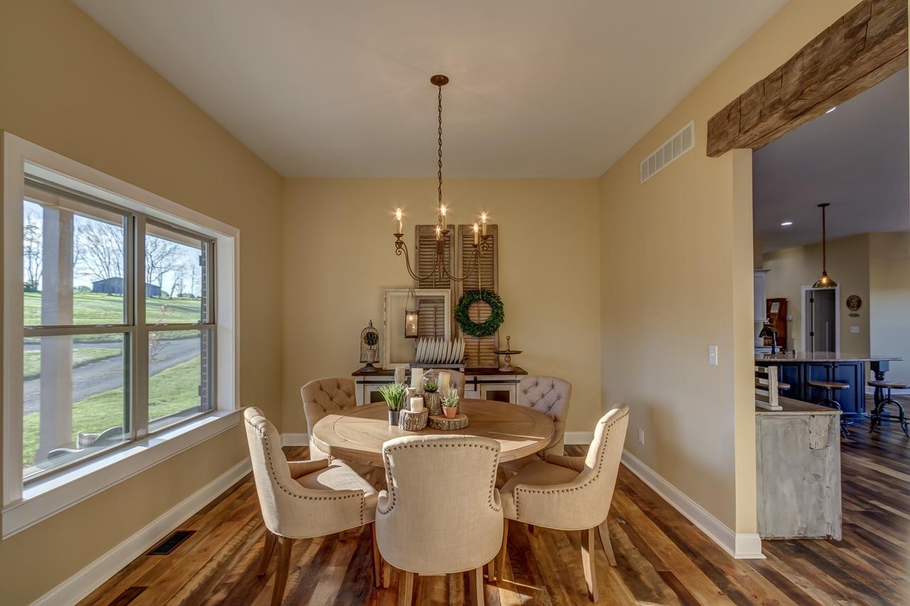 Heartland Barnwood Oak Red & White Mixed Skip-Planed Brown wood flooring in dining area with dining table under chandelier.