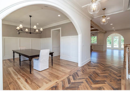 Heartland Barnwood Oak Red & White Mixed Skip-Planed Brown wood flooring in common area viewed from stairs with white walls