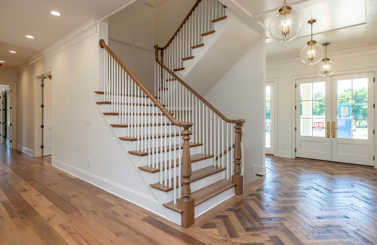 Heartland Barnwood Oak Red & White Mixed Skip-Planed Brown wood flooring   in entrance and common area with stairs