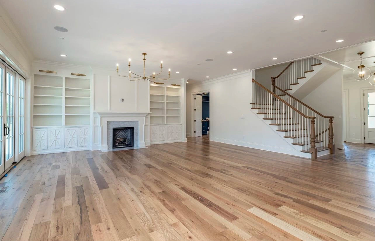 Heartland Barnwood Oak Red & White Mixed Clean Face wood flooring in living room with white walls and fireplace