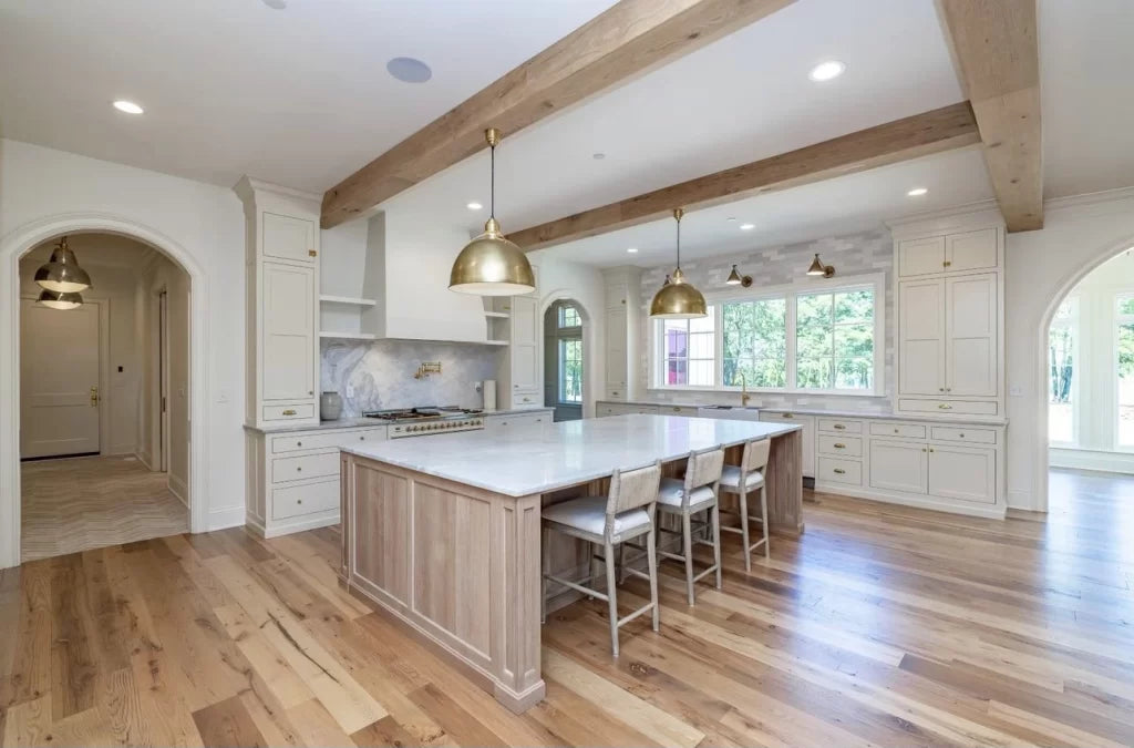 Heartland Barnwood Oak Red & White Mixed Clean Face wood flooring in kitchen with island style table  with hand hewn beams in ceiling