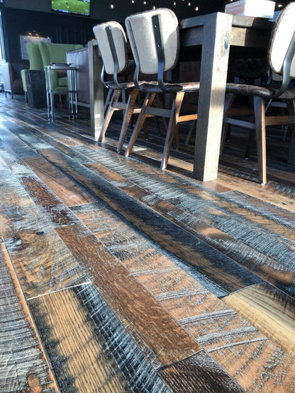 close up of Heartland Barnwood Oak Red & White Mixed Skip-Planed Brown wood flooring  in business common area