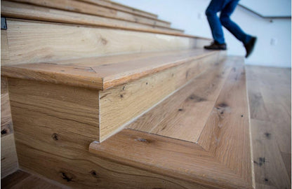 Close up of Racehorse Oak Red & White Mix Clean Face wood flooring used on stairs with person walking up the stairs