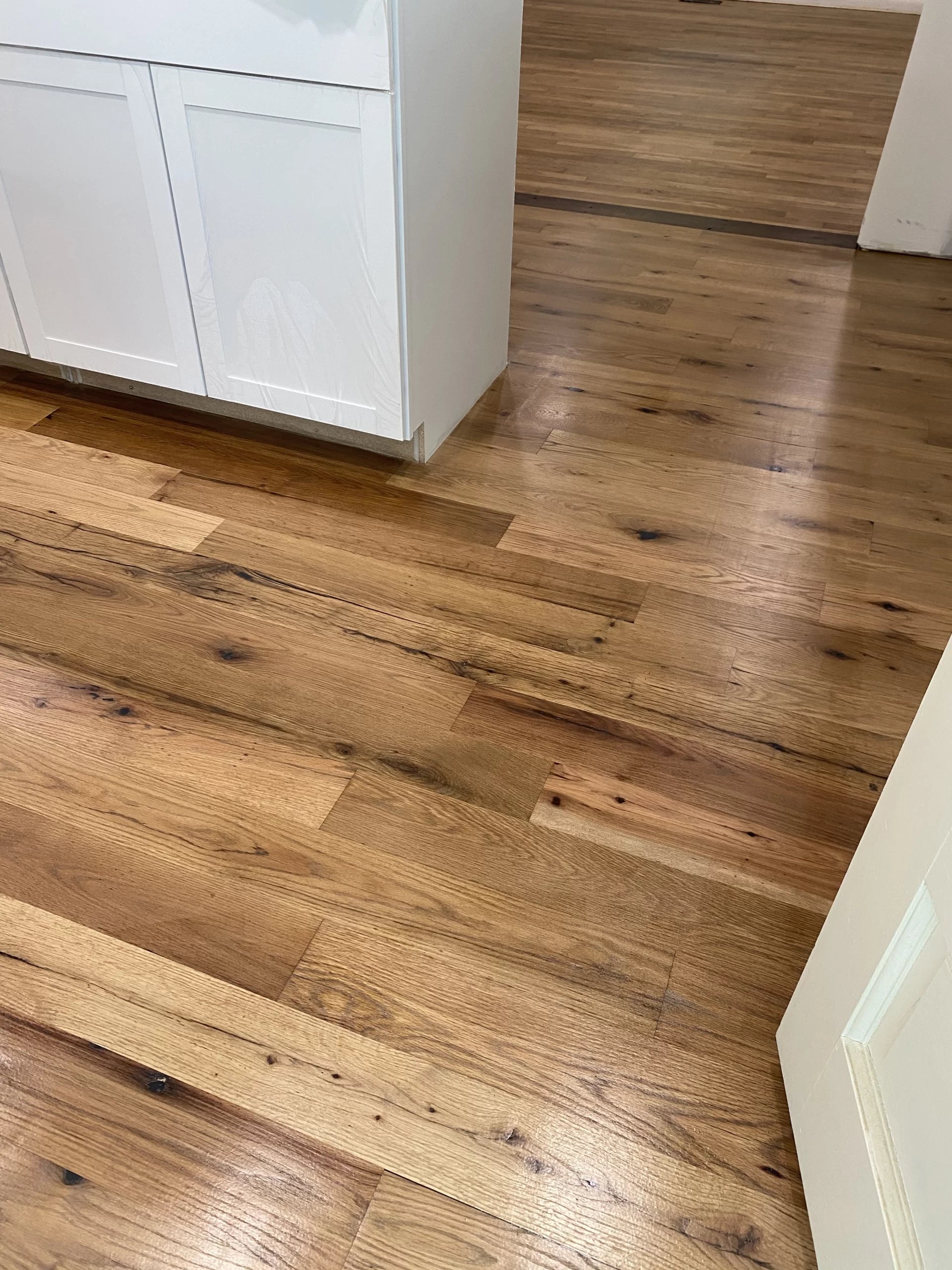 Close up of Racehorse Oak Red & White Mix Clean Face wood flooring in kitchen area