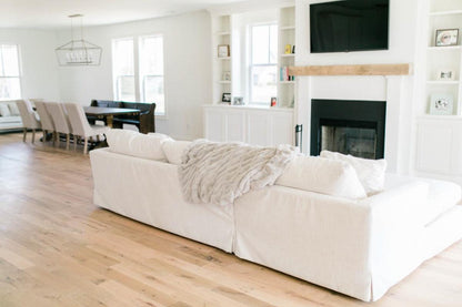 Racehorse Oak Red & White Mix Clean Face wood flooring in living room area with white couch