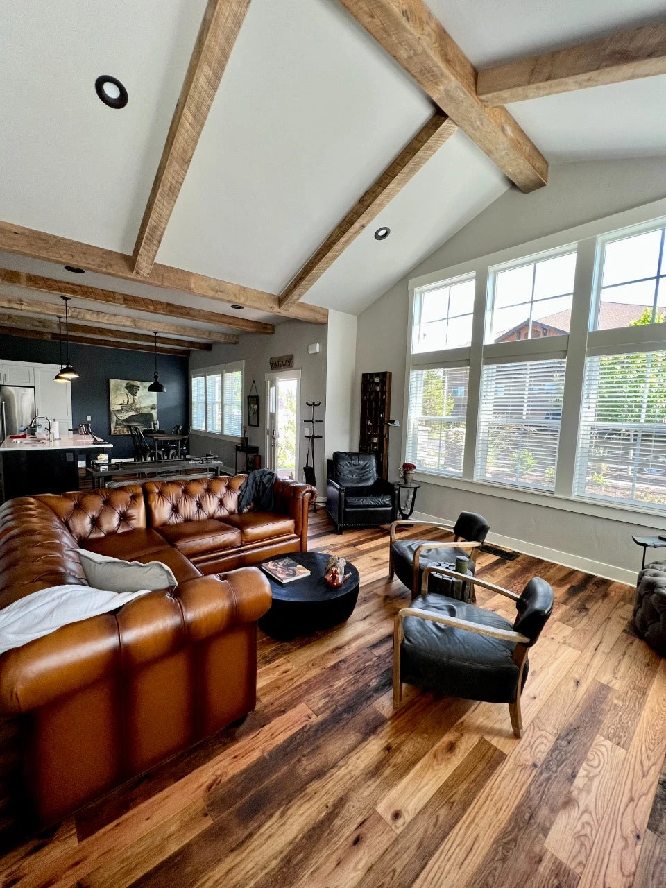 Racehorse Oak Red & White Mix Skip/Wire-Brushed flooring in living area with modern vintage furniture with hand hewn beams in ceiling