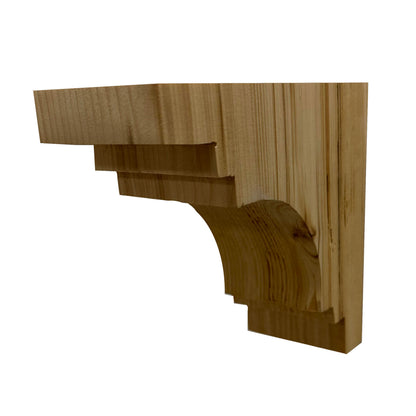 decorative corbel made from reclaimed barnwood. Wood grain displayed on the side and corbel shown in a decorative profile. There are three small steps at the top of the corbel before the arch. Below the arch is another two steps.