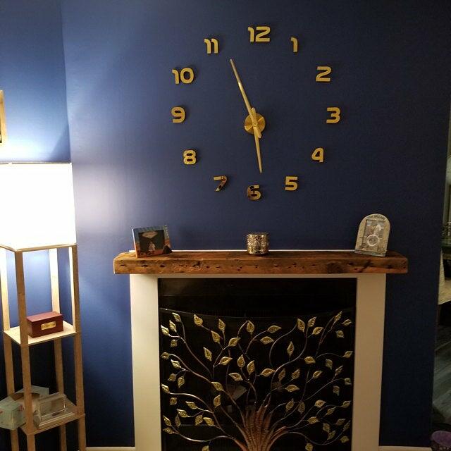a reclaimed wood floating fireplace mantel in the oil finish. Variations of wood color, nail holes, knots, and other characteristics displayed in the mantel.