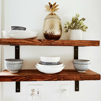 two reclaimed barnwood wall shelves in the oil finish. The oil finish brings out the grain pattern in the wood. Shelves are shown close up and decorated with various platters, plates, and bowls.