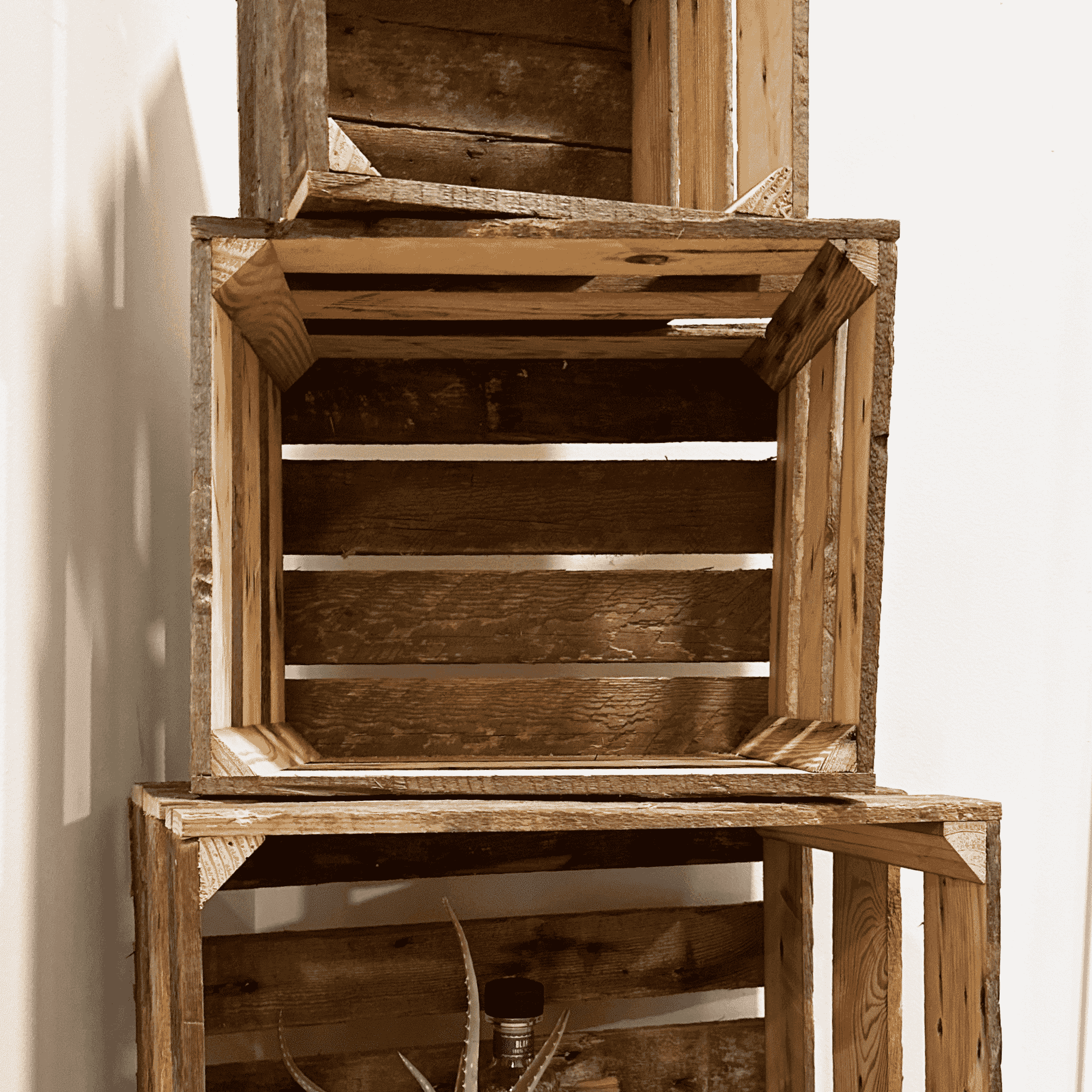 a close up of three reclaimed wooden crates stacked on top of one another in a small, medium, and large size. Shows inside of crates displaying wood variation  and construction.