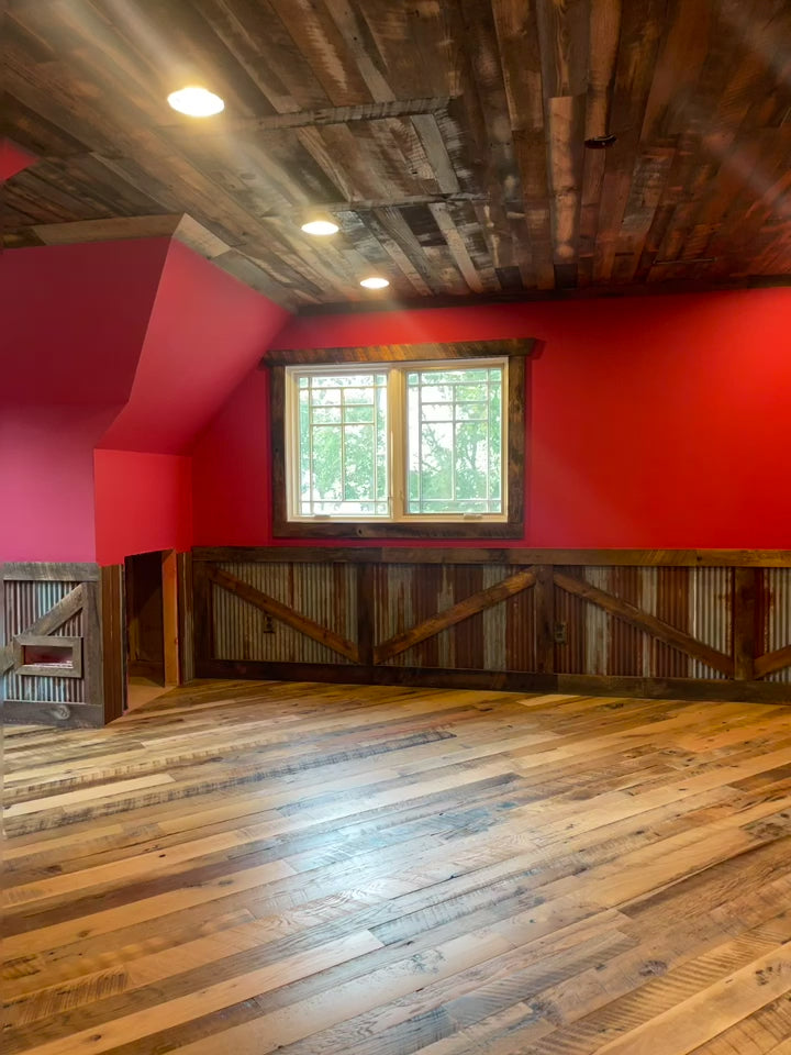 Video of Heartland Barnwood Mixed Hardwoods Skip-Planed Brown flooring and red walls with wood wall trim in barn style room 