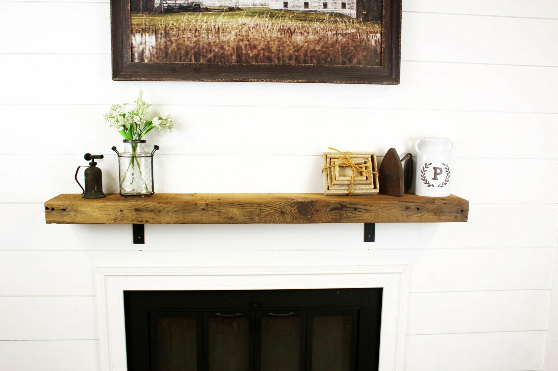 skip-planed reclaimed barnwood fireplace mantel shown in the natural option. Grain patterns, knots, and nail holes are present in the face of the mantel.