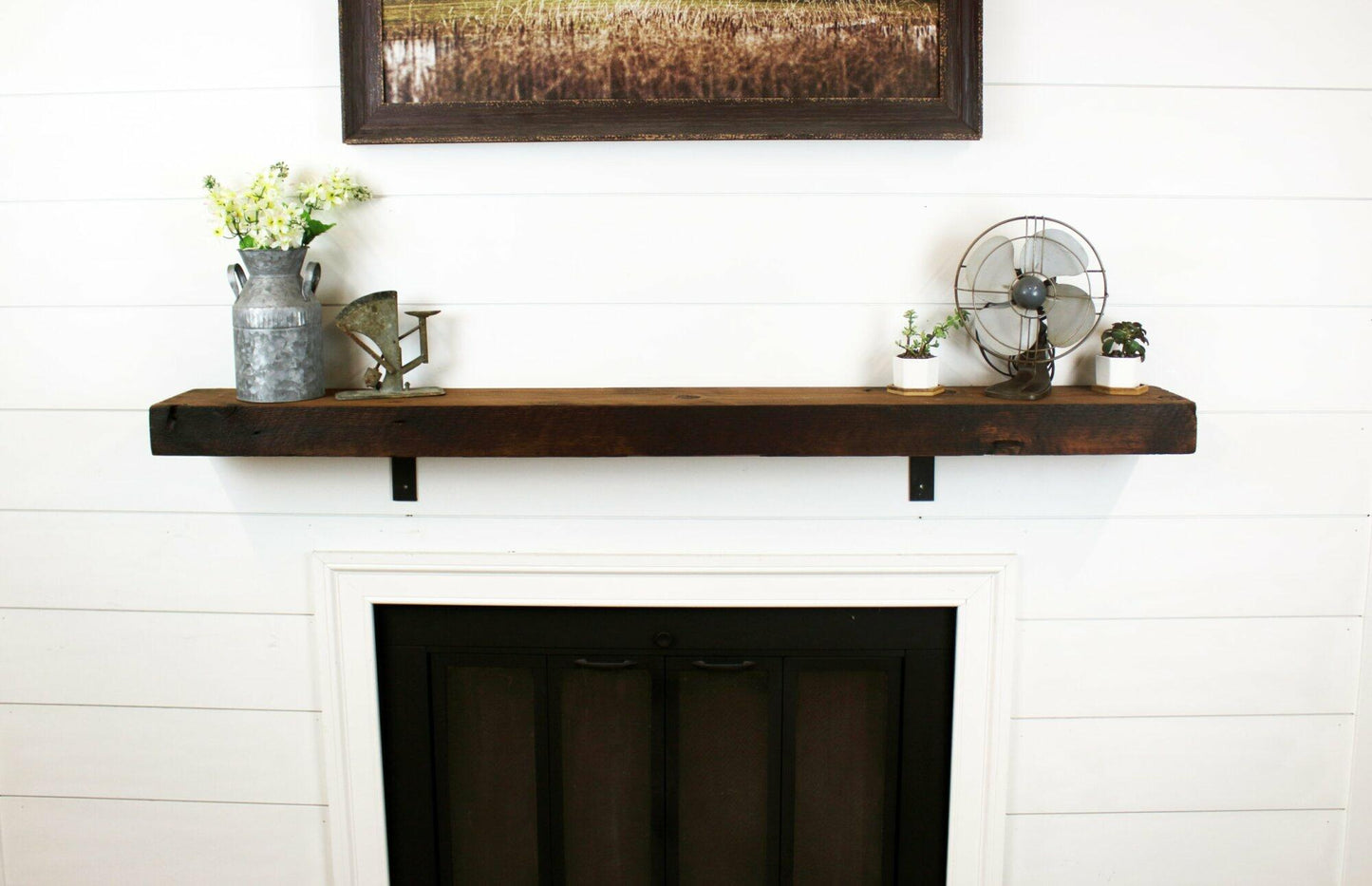 skip-planed reclaimed barnwood fireplace mantel. Front face is darker than top side of mantel.